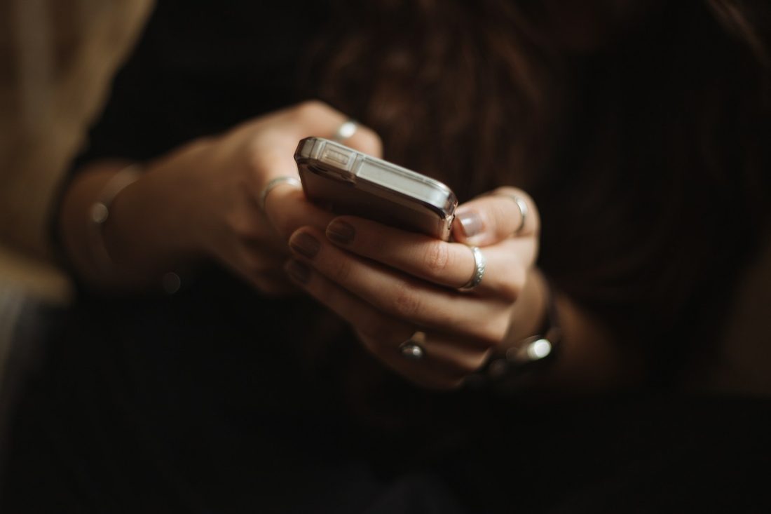 A supporter reading a text message on their phone